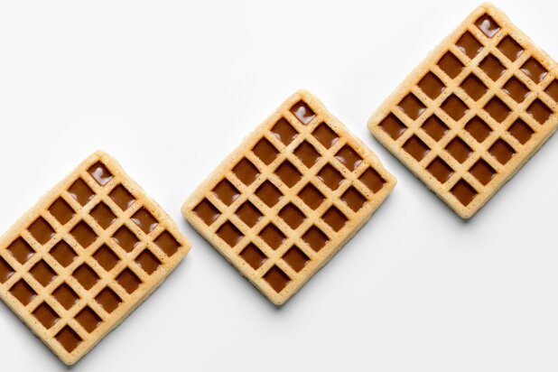 Three square waffles with compound in every cavity, on a white background